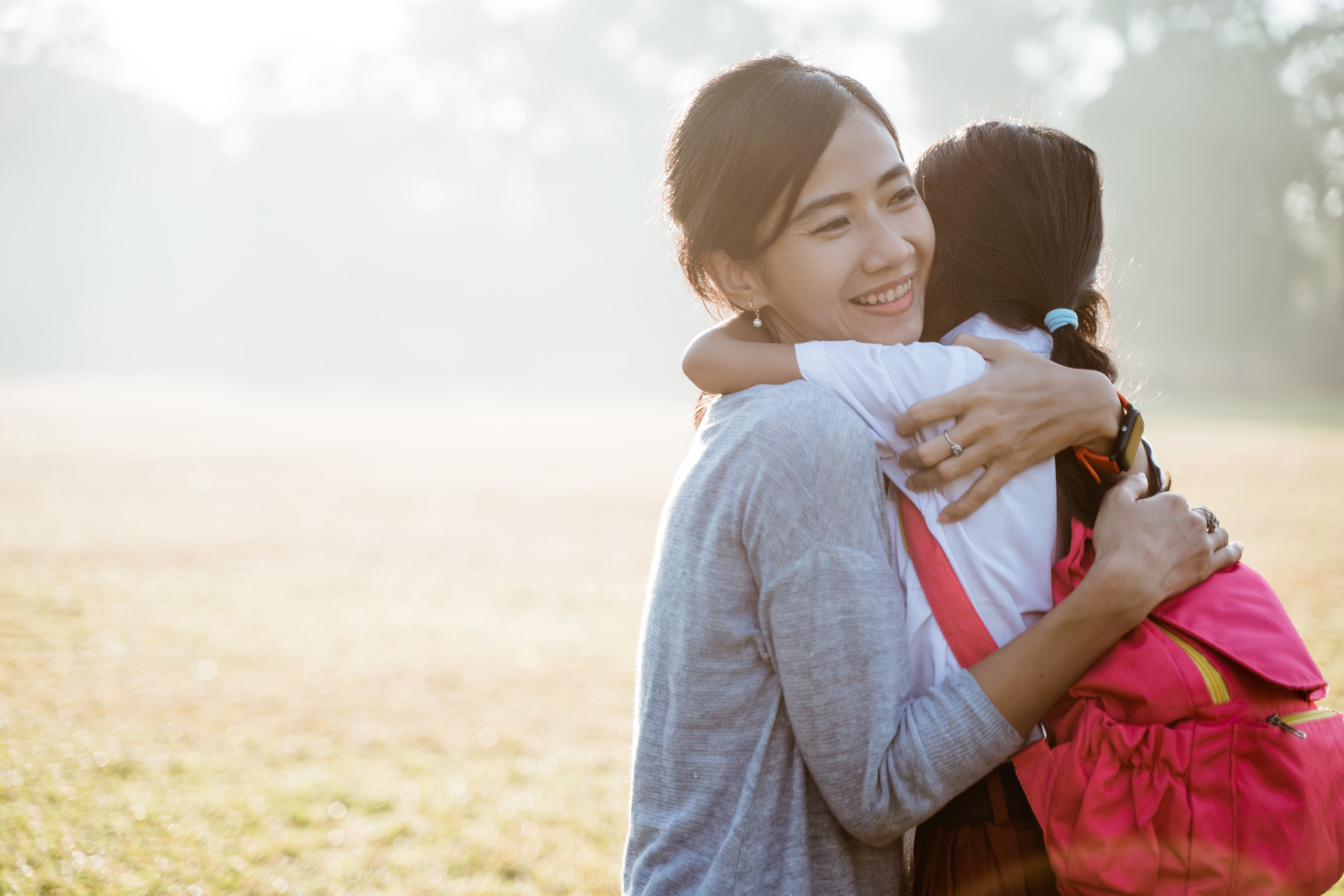 asian-mother-embrace-hug-her-daughter-going-school