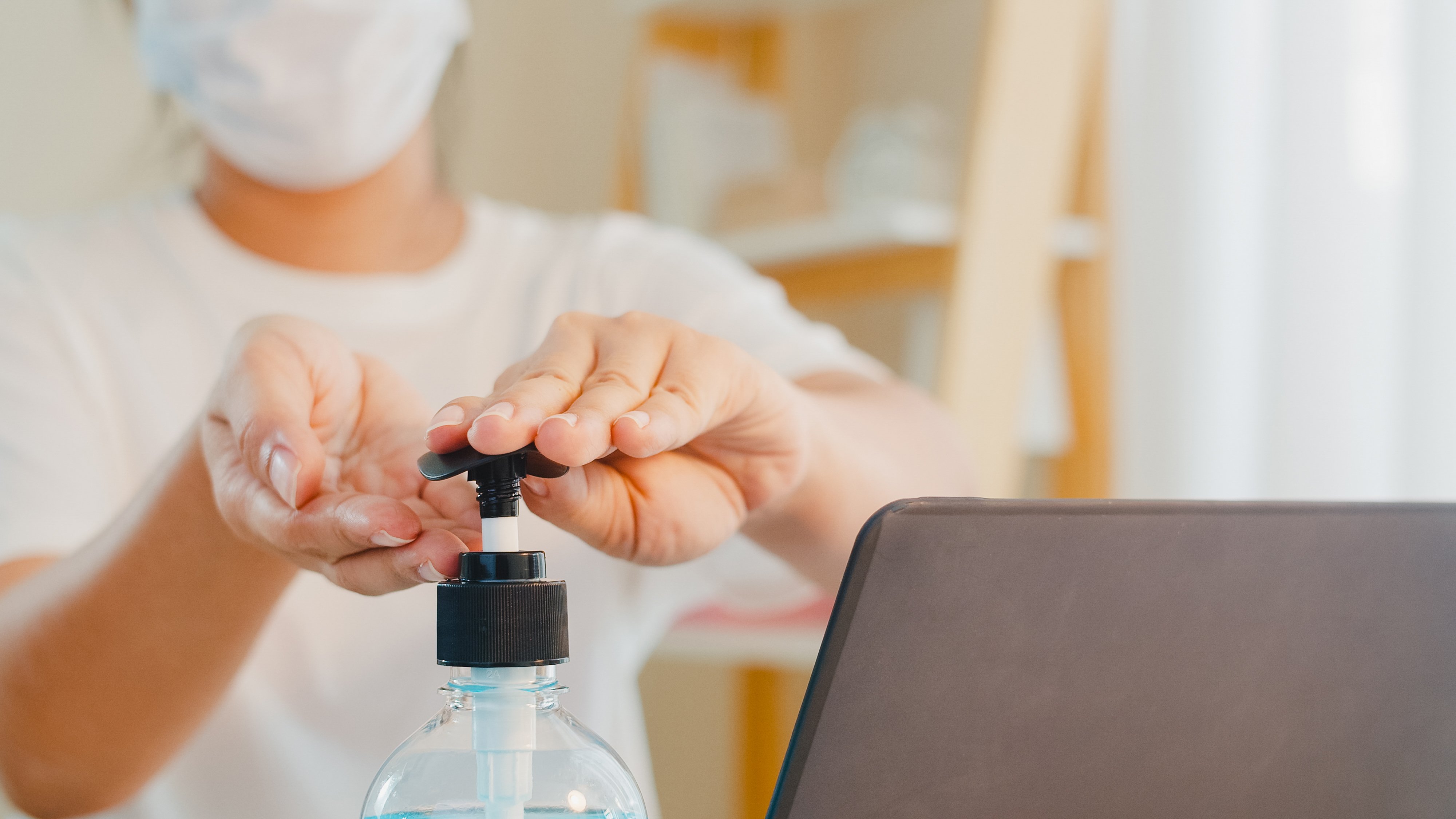 asian-woman-using-alcohol-gel-hand-sanitizer-wash-hand-before-open-laptop-protect-coronavirus-female-push-alcohol-clean-hygiene-when-social-distancing-stay-home-self-quarantine-time