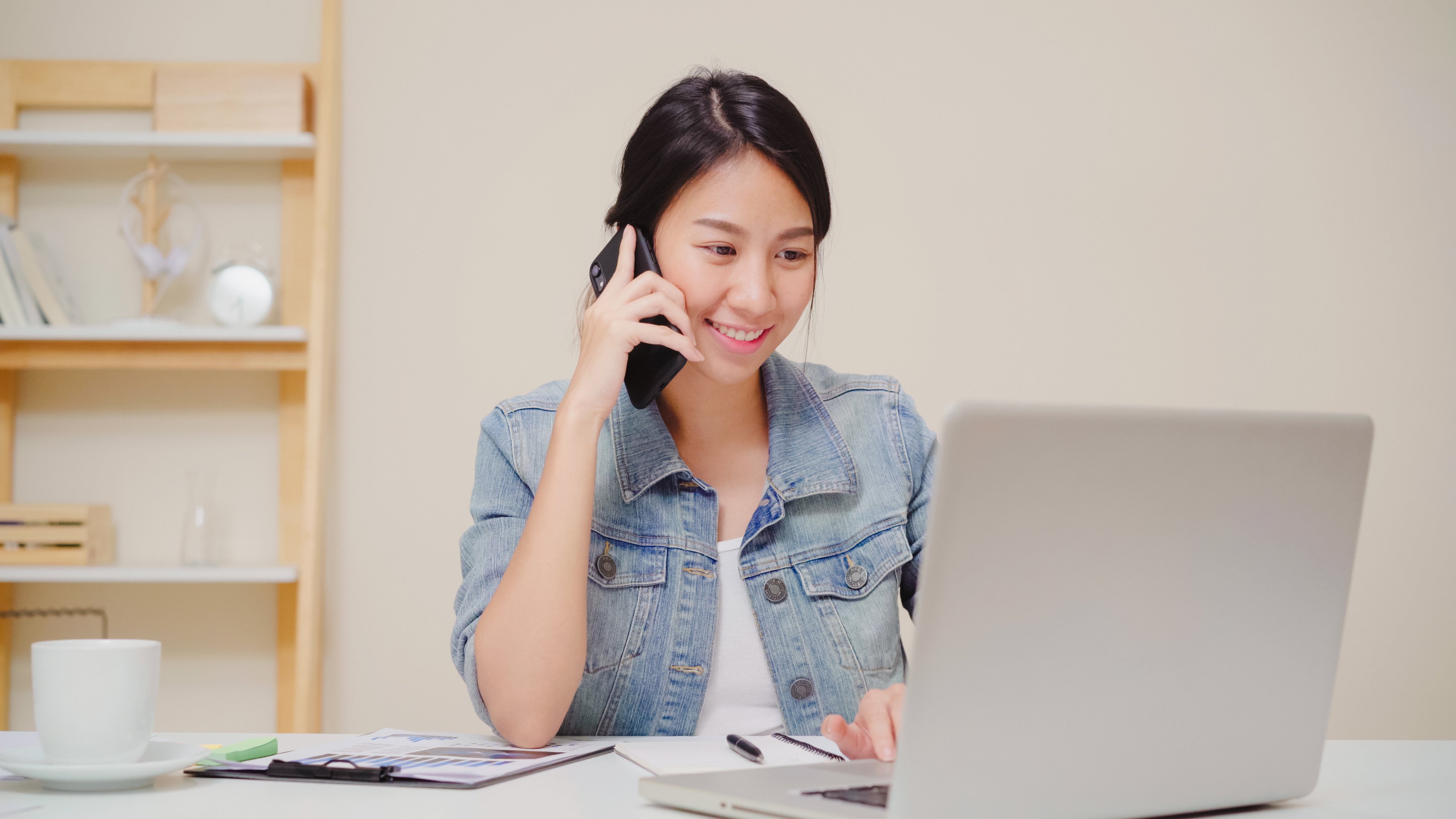 beautiful-smart-business-asian-woman-smart-casual-wear-working-laptop-talking-phone-while-sitting-table-creative-office