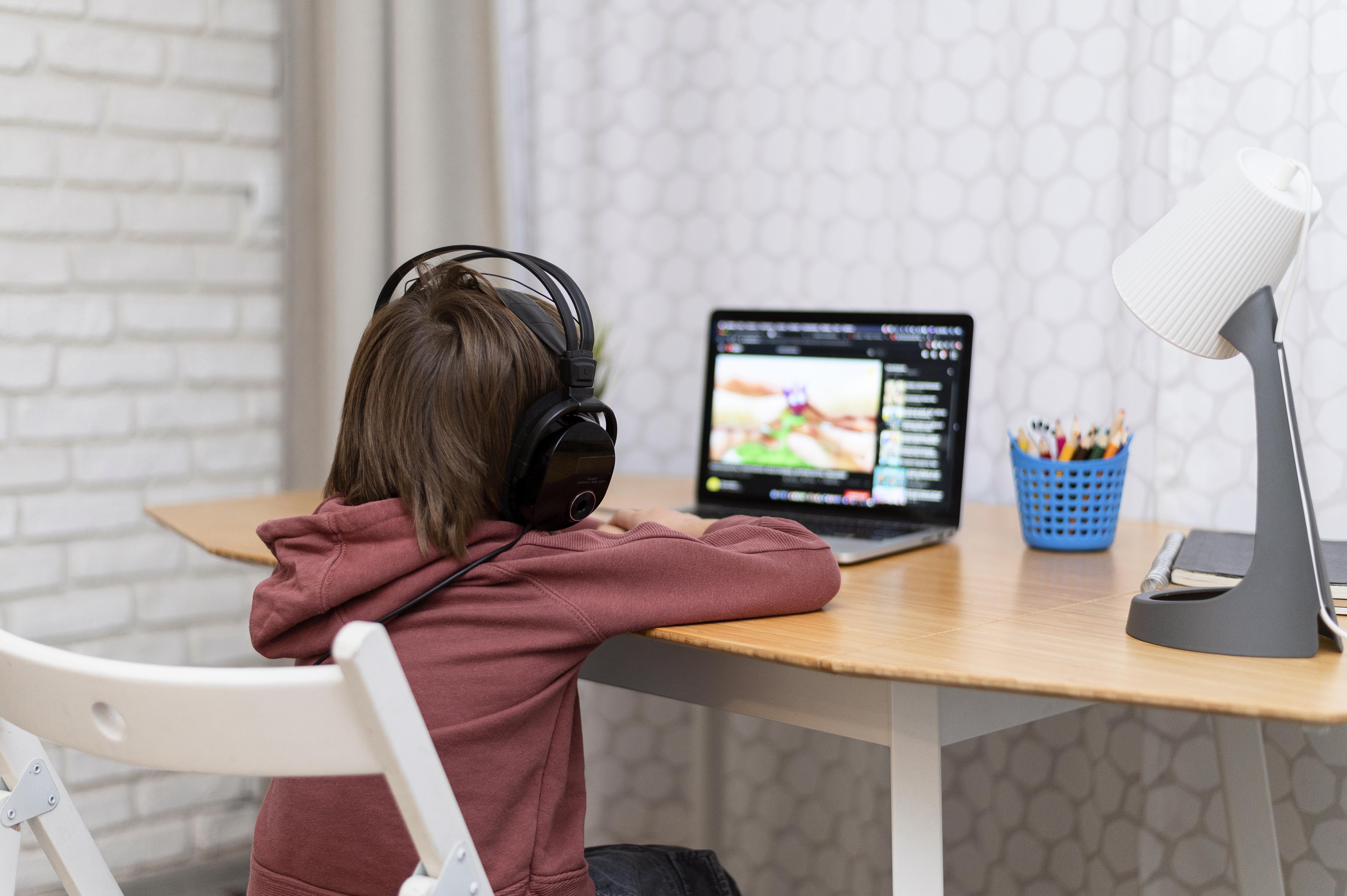 child-wearing-headphones-attending-online-courses