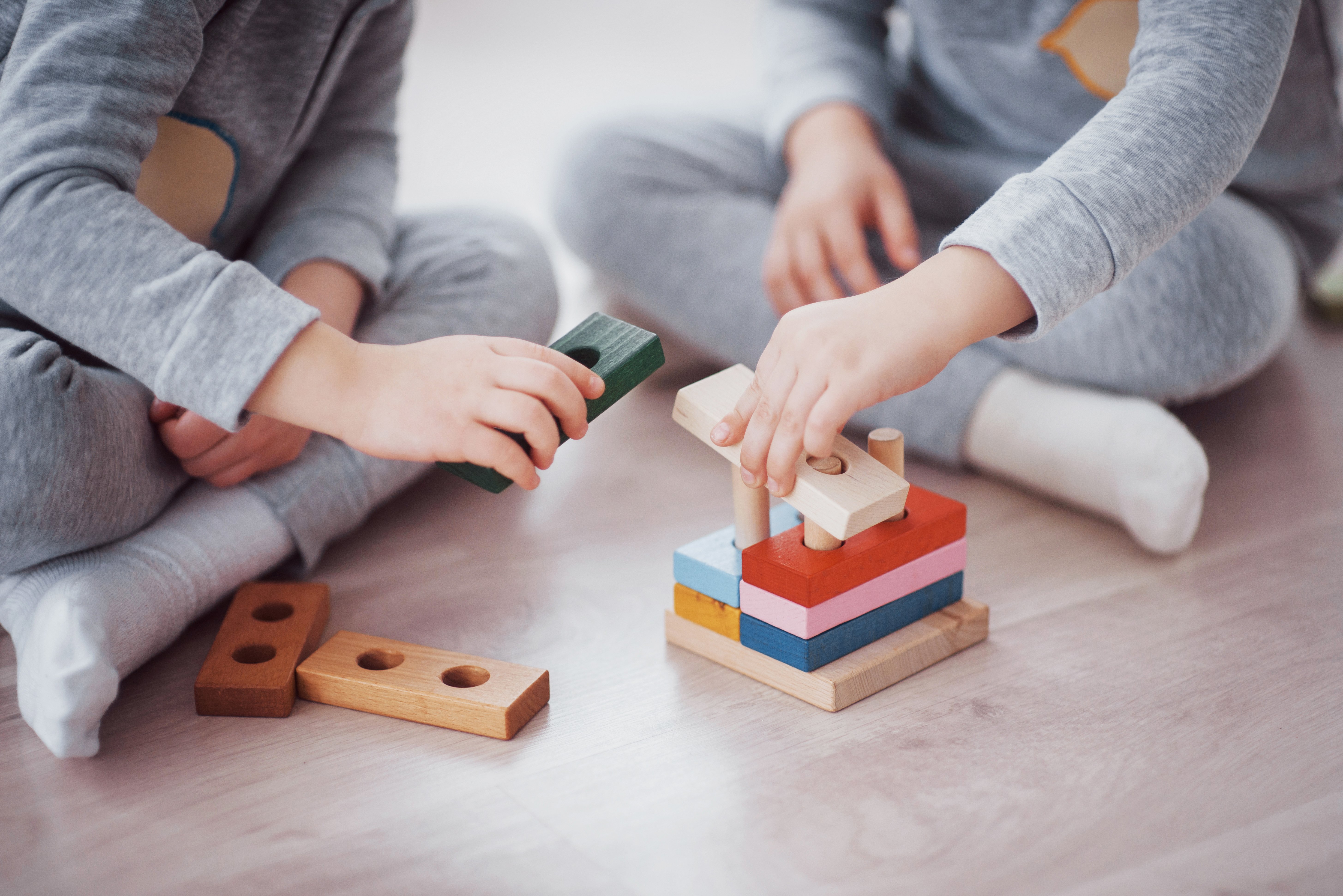 children-play-with-toy-designer-floor-children-s-room-two-kids-playing-with-colorful-blocks-kindergarten-educational-games