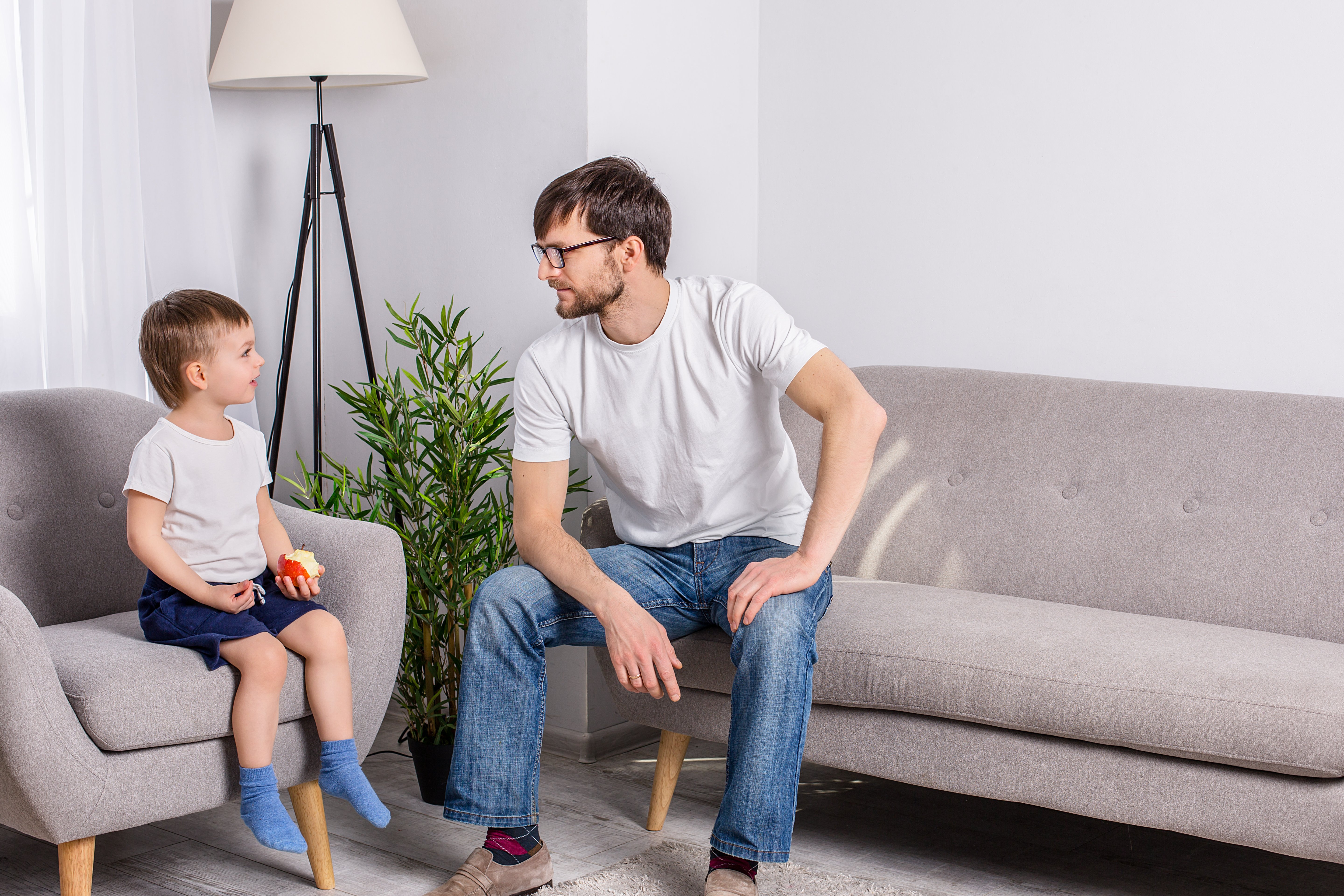 father-young-son-discussing-something-serious-living-room-home-family-trust