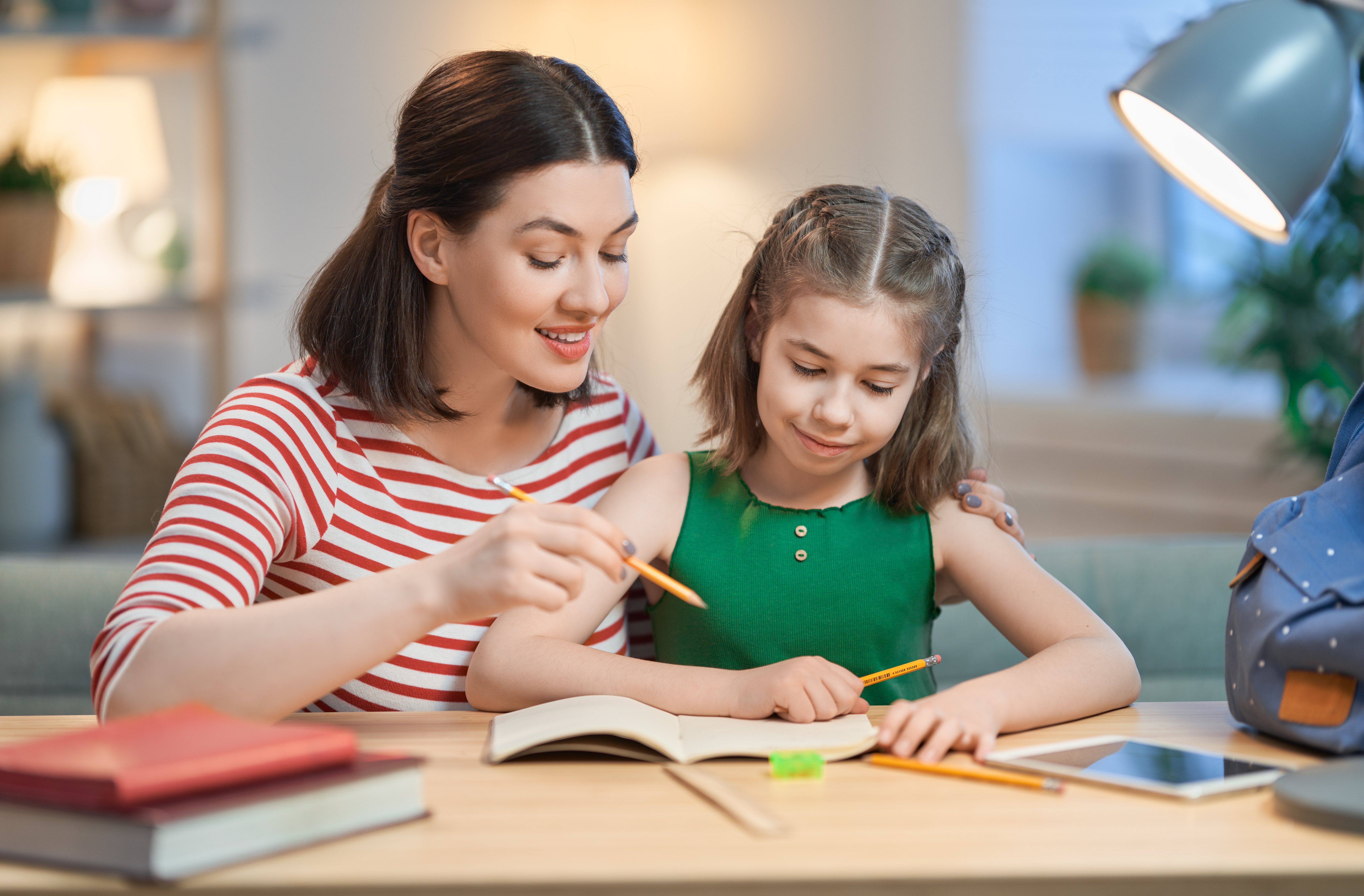 girl-doing-homework-with-mother