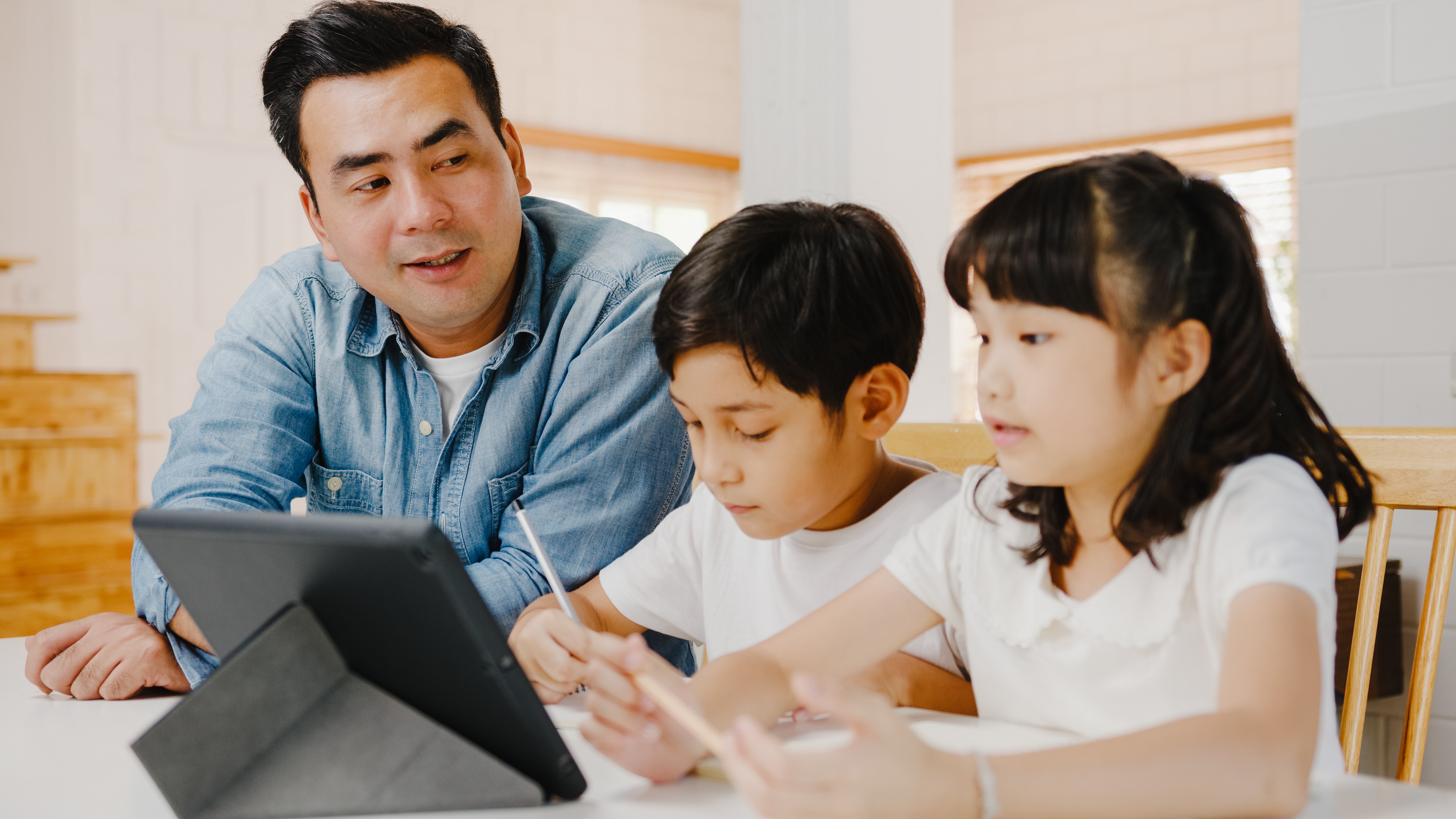 happy-asia-family-homeschooling-father-teach-children-using-digital-tablet-living-room-home-1