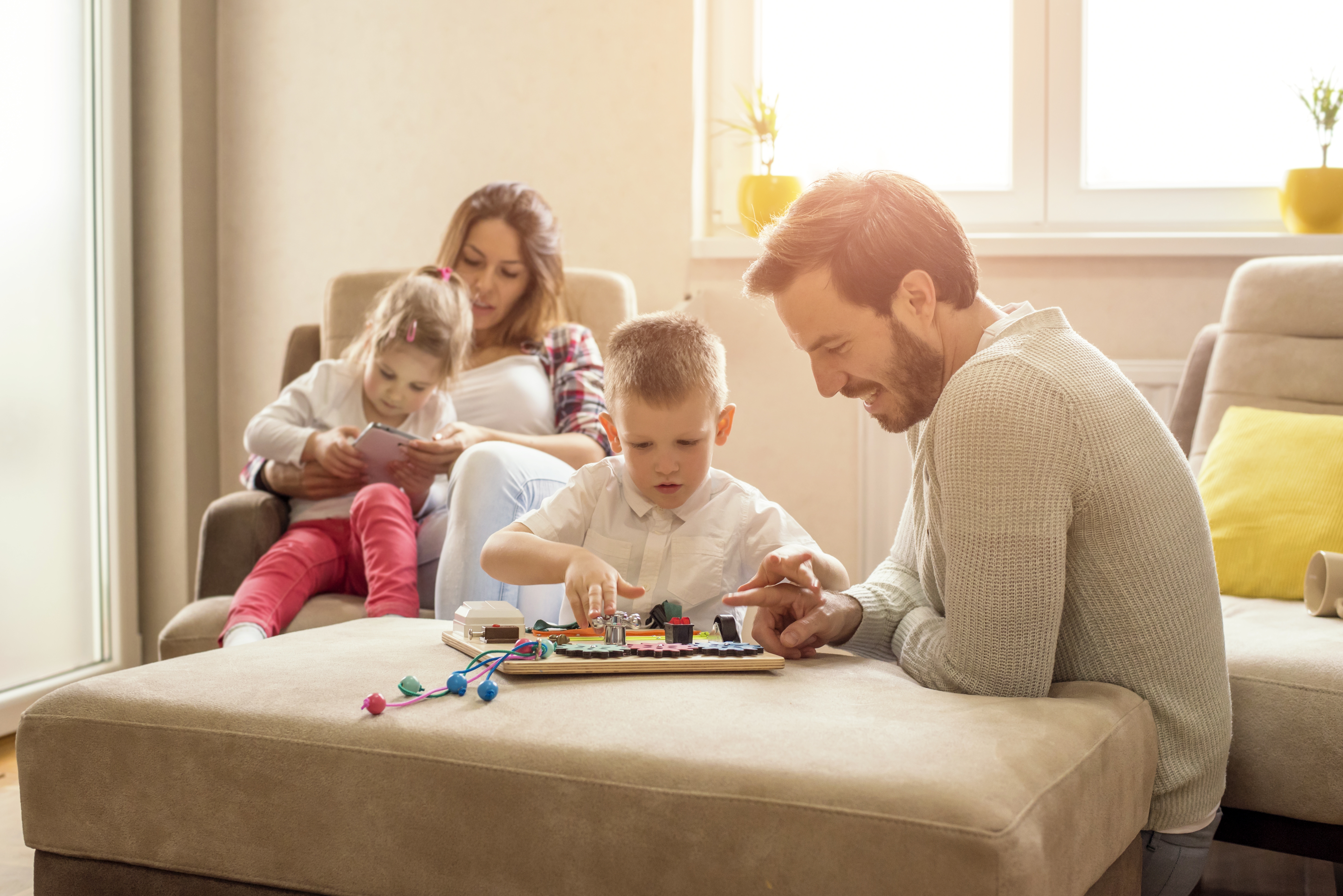 shallow-focus-shot-happy-caucasian-family-reading-playing