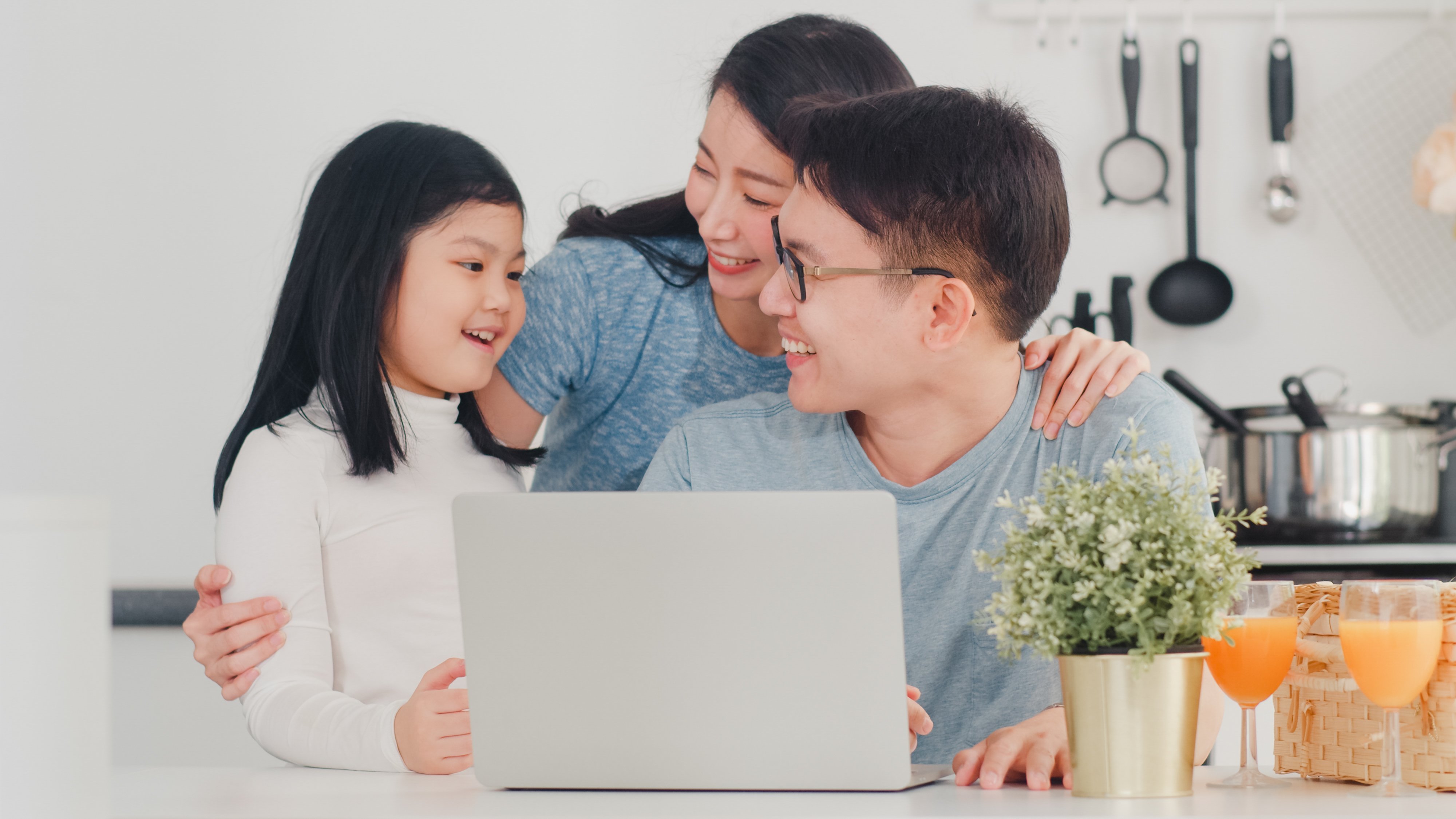 young-asian-family-enjoy-using-laptop-together-home-lifestyle-young-husband-wife-daughter-happy-hug-play-after-have-breakfast-modern-kitchen-house-morning-2